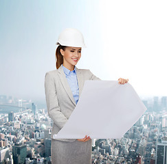 Image showing smiling architect in white helmet with blueprints