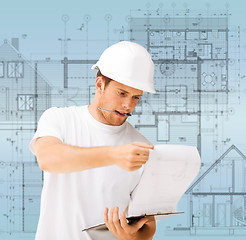 Image showing male architect looking at blueprint