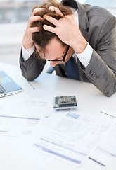 Image showing businessman with papres, laptop and calculator