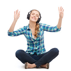 Image showing young woman listeting to music with headphones