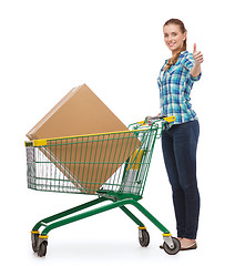 Image showing smiling young woman with shopping cart