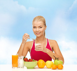 Image showing young woman eating healthy breakfast