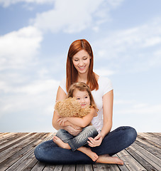 Image showing happy mother with adorable girl and teddy bear