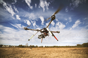 Image showing Quadrocopter drone flying in the sky