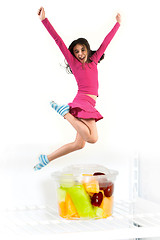 Image showing teen jumping over fruit cup