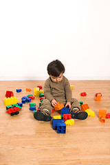 Image showing baby playing on laminated flooring