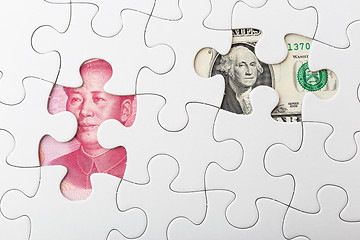 Image showing US and chinese yuan with white puzzle for exchange rate concept