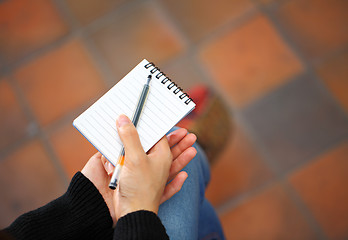 Image showing Woman hand with notepad and pen