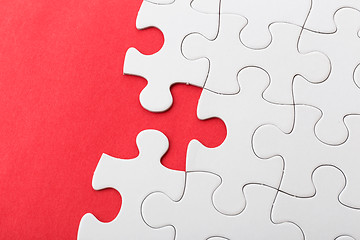 Image showing White puzzle on red background