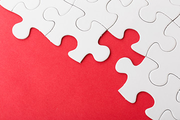 Image showing Incomplete puzzle over red background