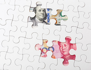 Image showing White puzzle with US and chinese banknote