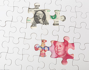 Image showing White puzzle with American dollar and chinese yuan