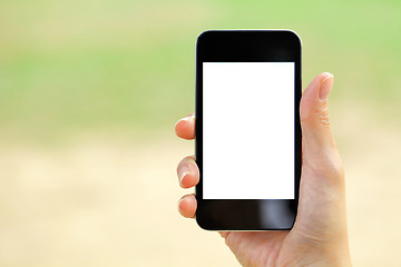 Image showing Blank screen mobile phone with woman hand