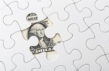 Image showing Dollar bill and puzzle piece