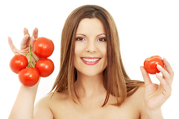 Image showing beautiful brunette girl holding tomatos