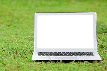 Image showing Laptop with blank screen on green lawn