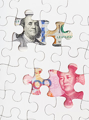 Image showing US dollar and chinese yuan with white puzzle