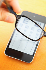 Image showing Eyechart on mobile screen with eyewear