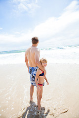 Image showing Father and happy young daughter at beach