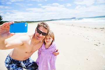 Image showing Father taking selfie photograph with daughter at beach