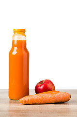 Image showing Bottle with carrots juice and an apple