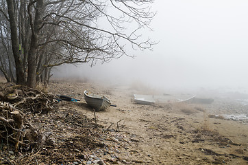 Image showing Old fishing boat at coast foggy in the morning