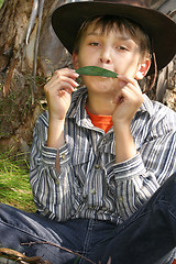 Image showing Green Music - A Boy playing gumleaf tune