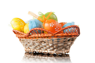 Image showing color easter eggs in basket isolated on white