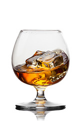 Image showing Splash of whiskey with ice in glass isolated on white background