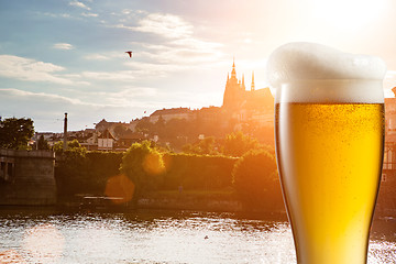 Image showing Glass of beer against view of the St. Vitus Cathedral in Prague