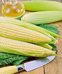 Image showing Corncob with a knife and oil on board