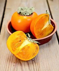 Image showing Persimmon on the board in pottery