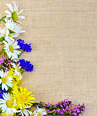 Image showing Frame of wild flowers on sacking