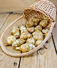 Image showing Jerusalem artichokes with basket on board