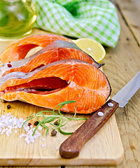 Image showing Trout with oil and knife on board