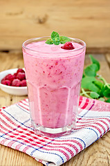 Image showing Milkshake with raspberries on board