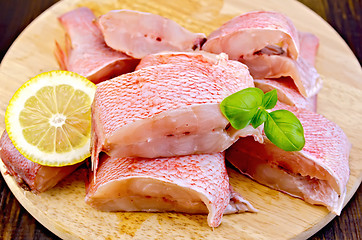 Image showing Fillet of sea bass with basil on board