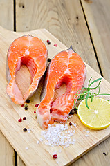 Image showing Trout on board with lemon and rosemary