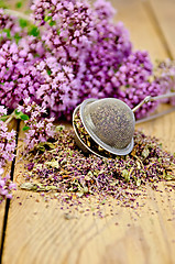 Image showing Herbal tea from dry and fresh oregano with strainer