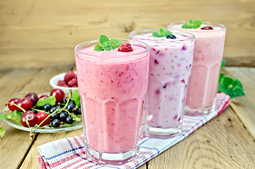 Image showing Milkshakes with berries in glass on board