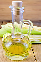 Image showing Corn oil in a carafe with corncobs on board