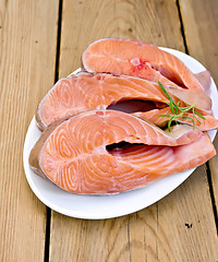 Image showing Trout in plate with rosemary on board