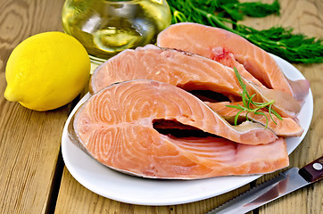 Image showing Trout in plate with lemon on board