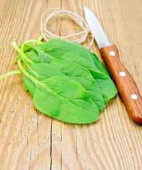 Image showing Spinach with a knife and twine on the board