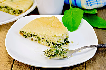 Image showing Pie spinach and cheese with fork on board