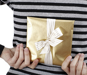 Image showing Young woman holding a present