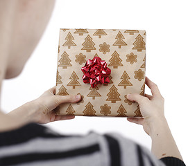 Image showing Young woman holding a present