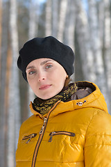 Image showing Woman in black beret and a yellow jacket.