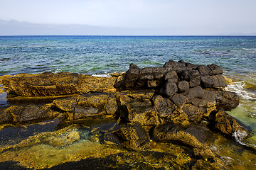 Image showing in lanzarote froth coastline  spain pond  rock stone sky cloud  