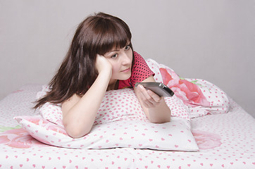 Image showing Girl in bed watching TV